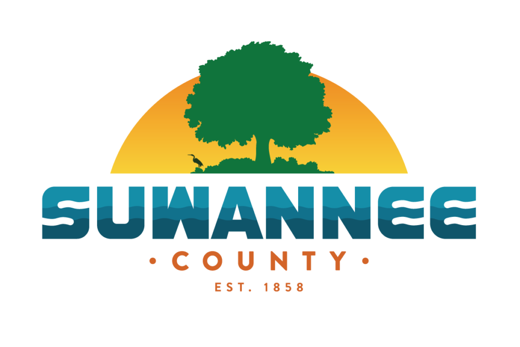 Suwannee County logo with a tree in front of a sunrise with text Suwannee County est. 1858 link to https://suwanneecountyfl.gov/