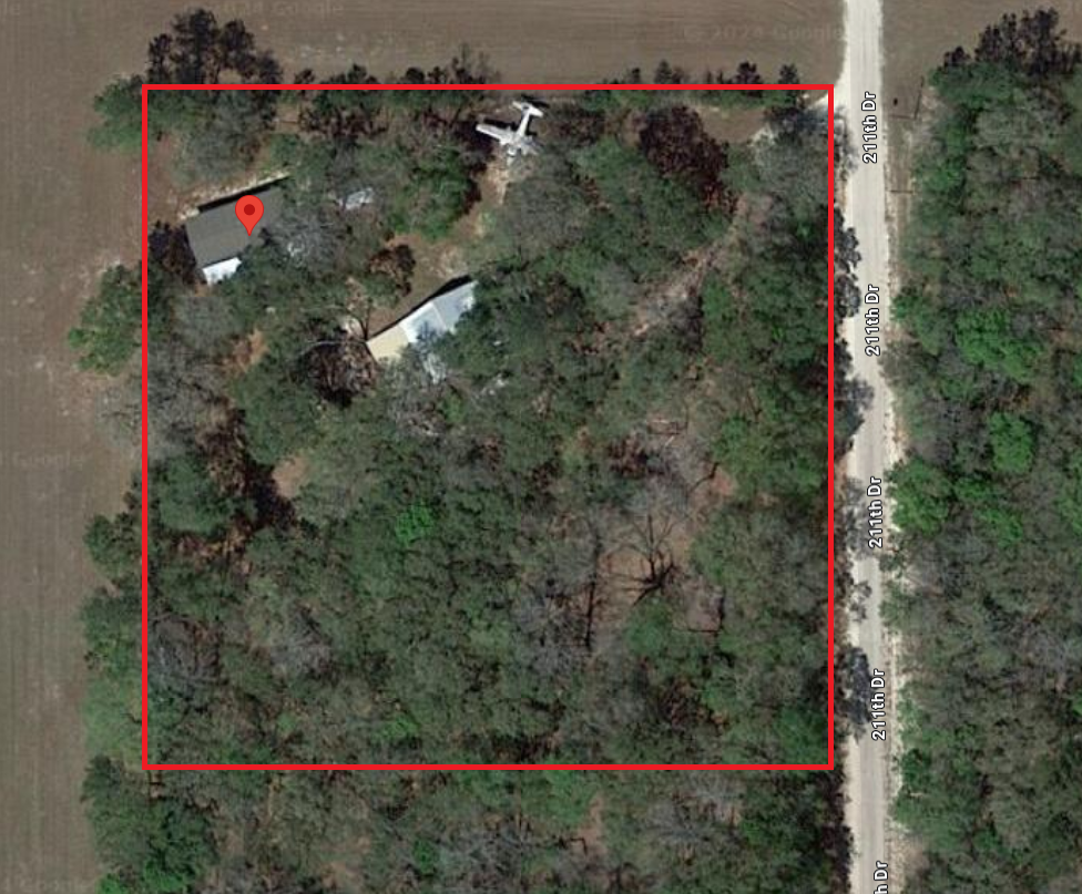 Aerial View of 18811 211th Drive showing location of the house, the hangar, trees and an airplane