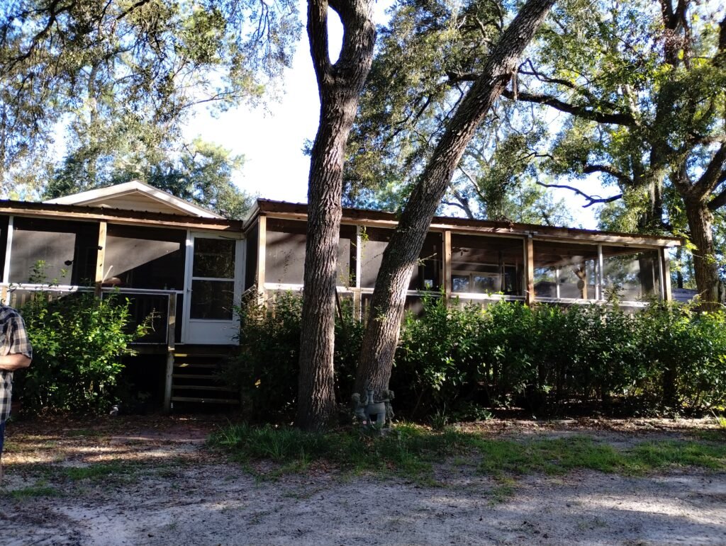 Front view of the house surrounded by oak trees